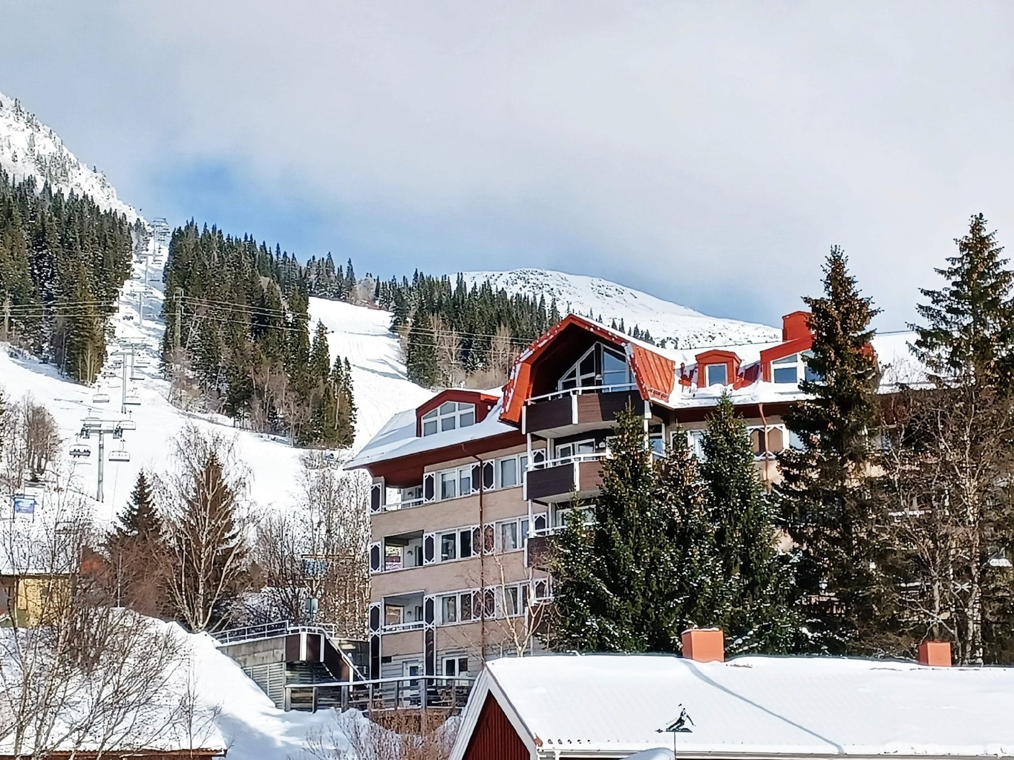 View apartment building with ski slope in the background