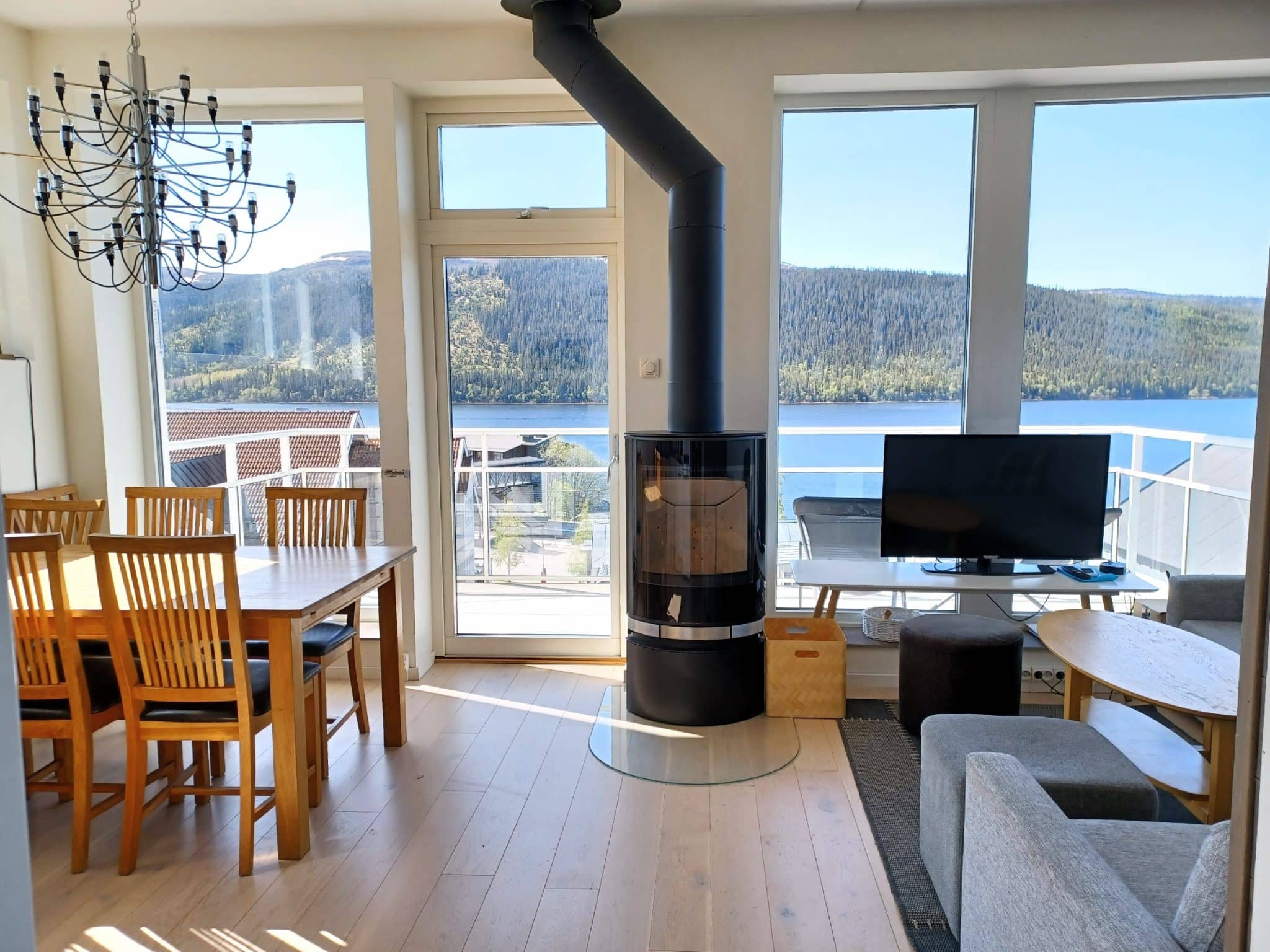 View of living room with panoramic window and wood stove
